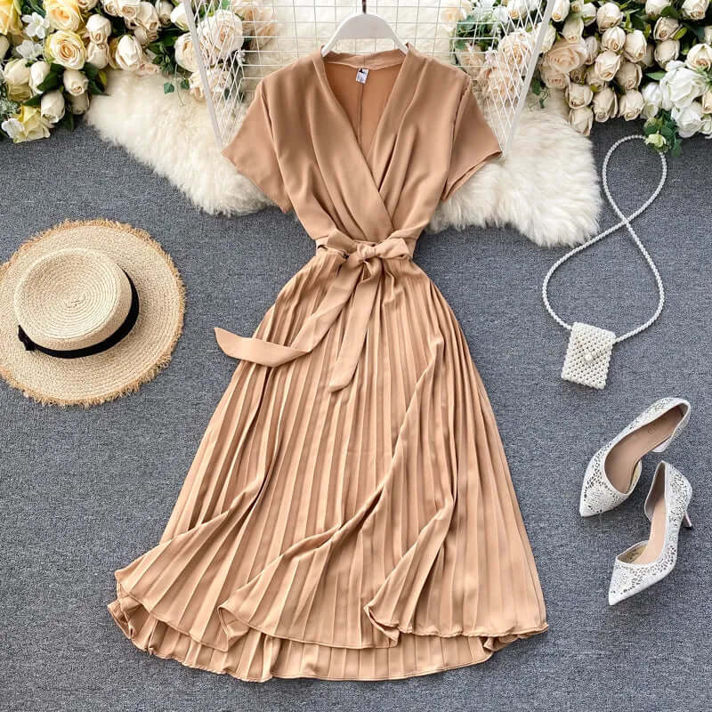 Chic black pleated midi dress for women, offering elegant versatility for summer outfits and event wear.