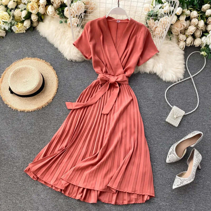 Women's elegant pleated midi dress featuring detailed pleats, perfect for a versatile and chic look.