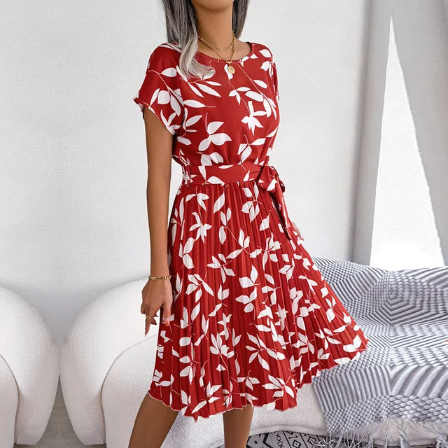 Elegant women's floral pleated midi dress with short sleeves and waist tie, ideal for spring.