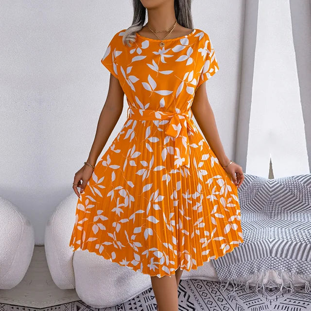 Detail shot: Elegant pleats & flattering waist tie on a women's short sleeve midi dress for summer.