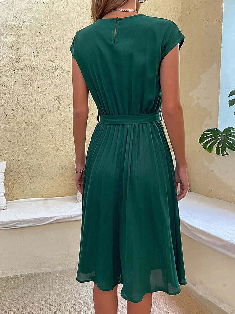 Flowy women's elegant midi dress, pleated skirt, cap sleeves, and tie waist detail for a sophisticated look.