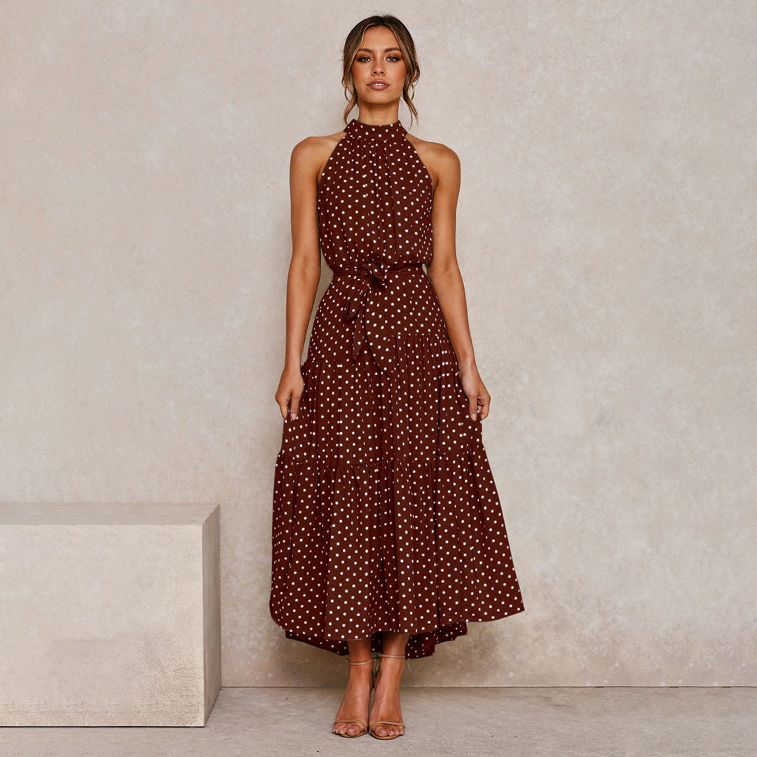Classic polka dot print on an elegant halter neck maxi dress for women, sleeveless and flowy.