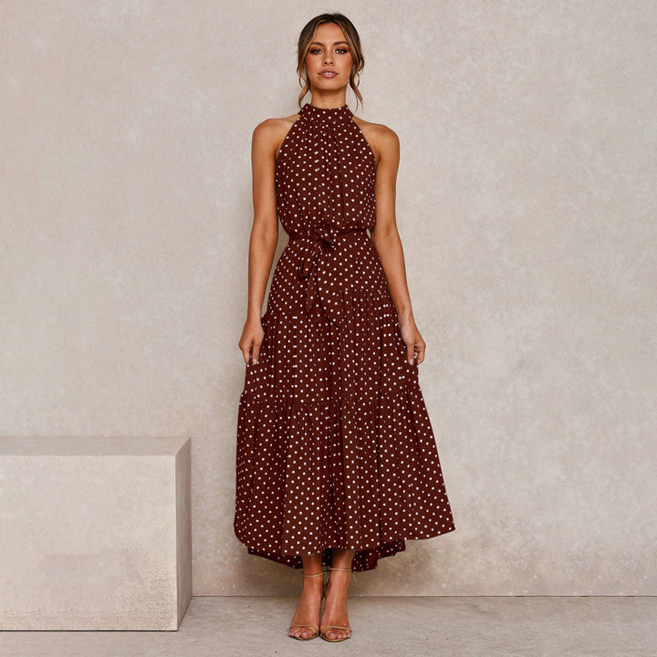 Classic polka dot print on an elegant halter neck maxi dress for women, sleeveless and flowy.