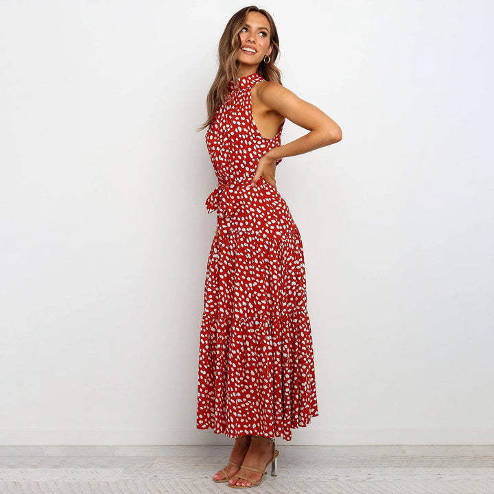 Women's elegant sleeveless polka dot maxi dress with tie waist and halter neck.