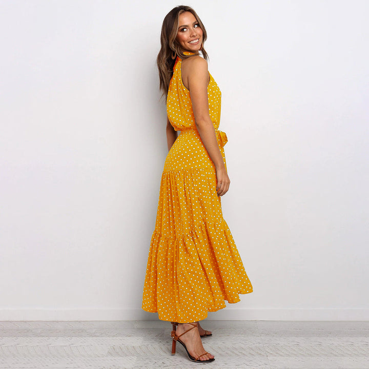 Women's sleeveless polka dot maxi dress, elegant halter neck & flowy design.