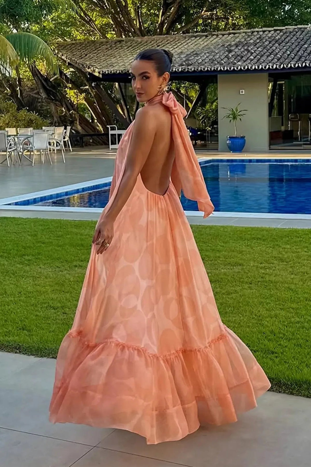 Flowy women's printed halter neck maxi dress in vibrant colors, ideal for a summer party or guest attire.