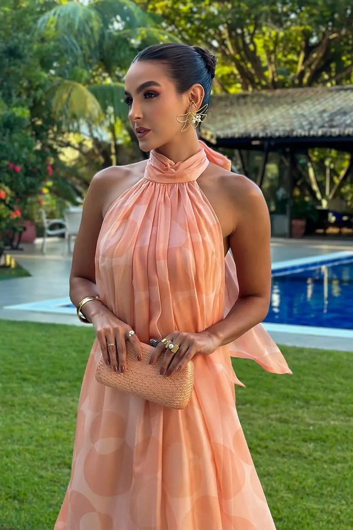 Chic orange printed halter neck maxi dress for women, an elegant choice for wedding guests & evening events.