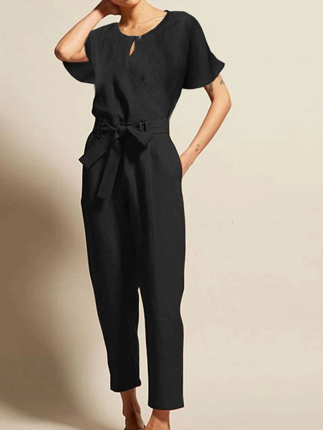 Comfortable women's short-sleeve summer jumpsuit with belt. Versatile one-piece for elegant casual wear and trendy fashion.
