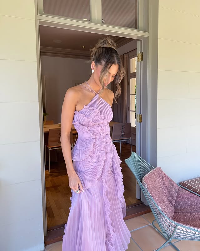 Close-up of a sophisticated women's halter maxi dress featuring flowing ruffles and a chic design.