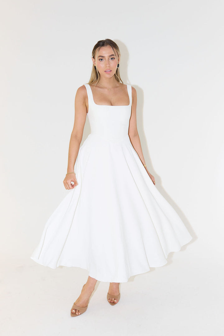 Chic women's sleeveless satin midi dress featuring a stylish square neck, ideal for cocktails & evening events.