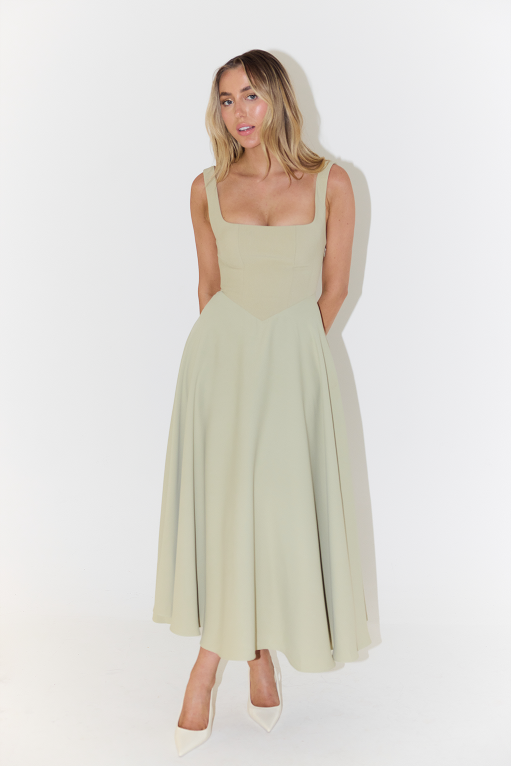Versatile women's sleeveless midi dress in luxurious satin, a stylish choice for cocktail or evening wear.
