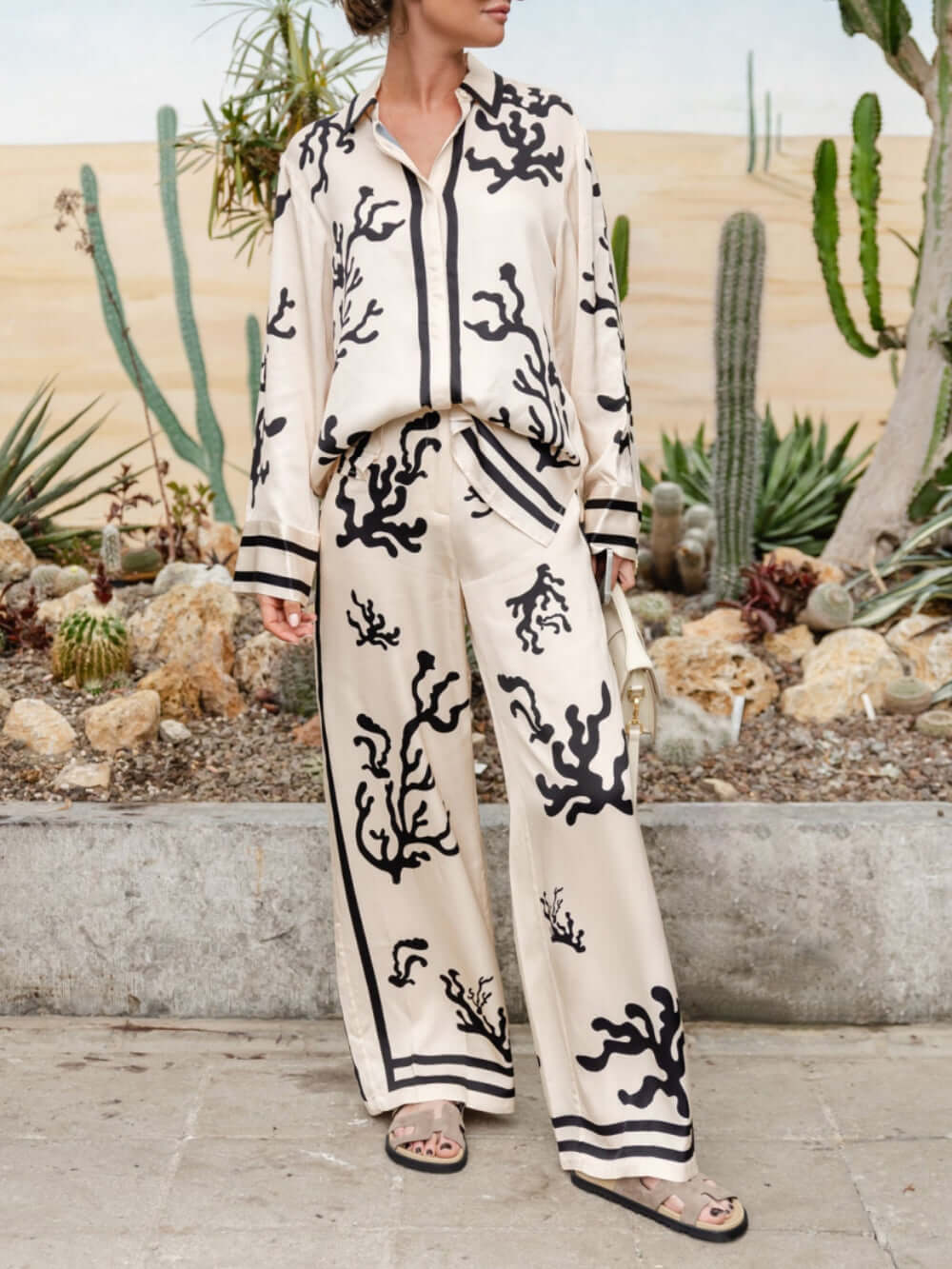 Sophisticated women's wide-leg pants and silk-like blouse set, perfect for dressy business or elegant casual wear.