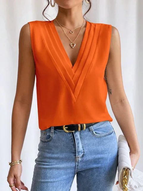 Chic women's sleeveless blouse featuring elegant pleats, designed for summer. Loose fit and breathable fabric top.