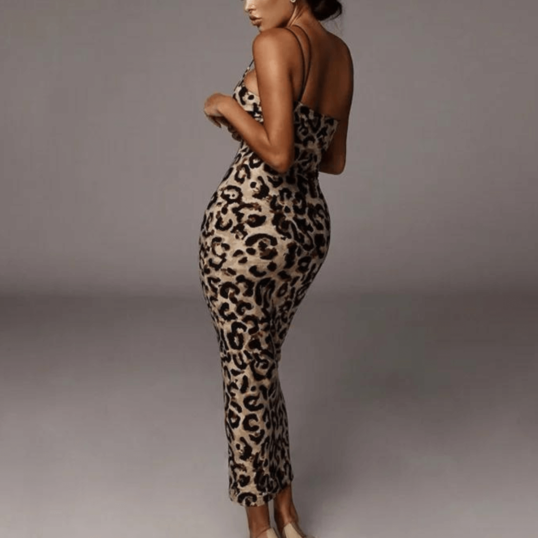 Close-up of elegant women's snake print midi dress, showcasing intricate pattern and flowing fabric.