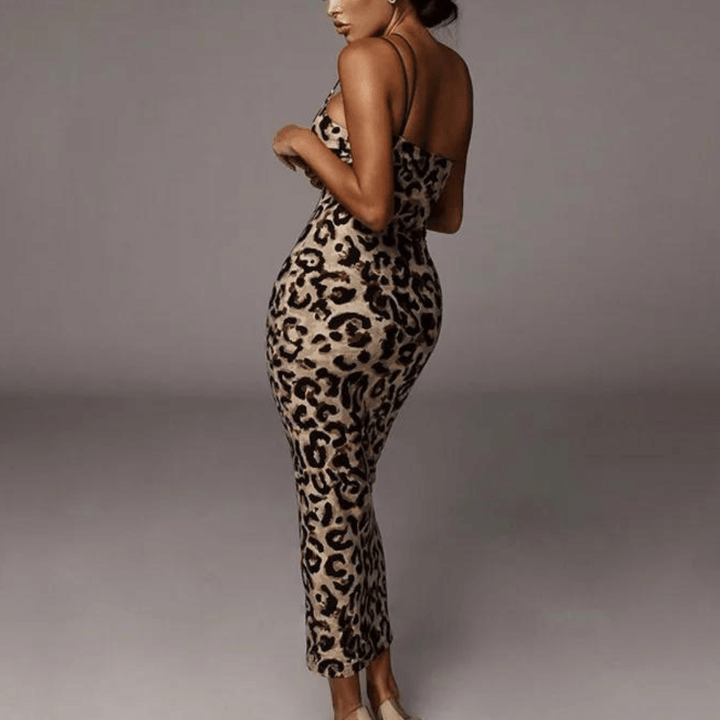 Close-up of elegant women's snake print midi dress, showcasing intricate pattern and flowing fabric.