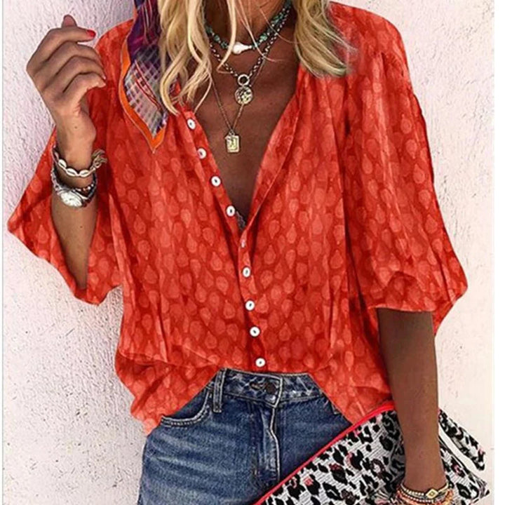 Colorful women's elegant blouse with airy, relaxed fit. Comfortable short sleeve summer top for versatile fashion.