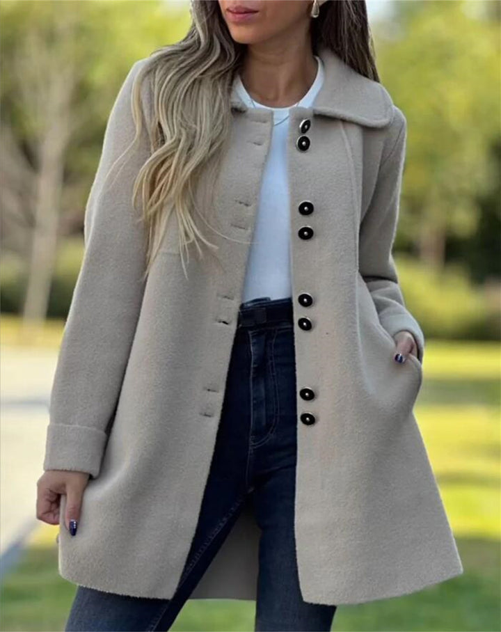 Elegant women's tailored coat, structured thigh-length style for professional autumn winter fashion.