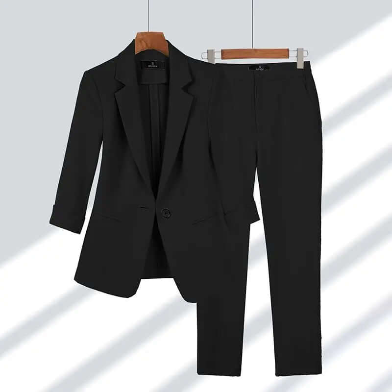 Close-up of a women's professional tailored suit, showing high-quality fabric and a stylish button detail on the blazer.