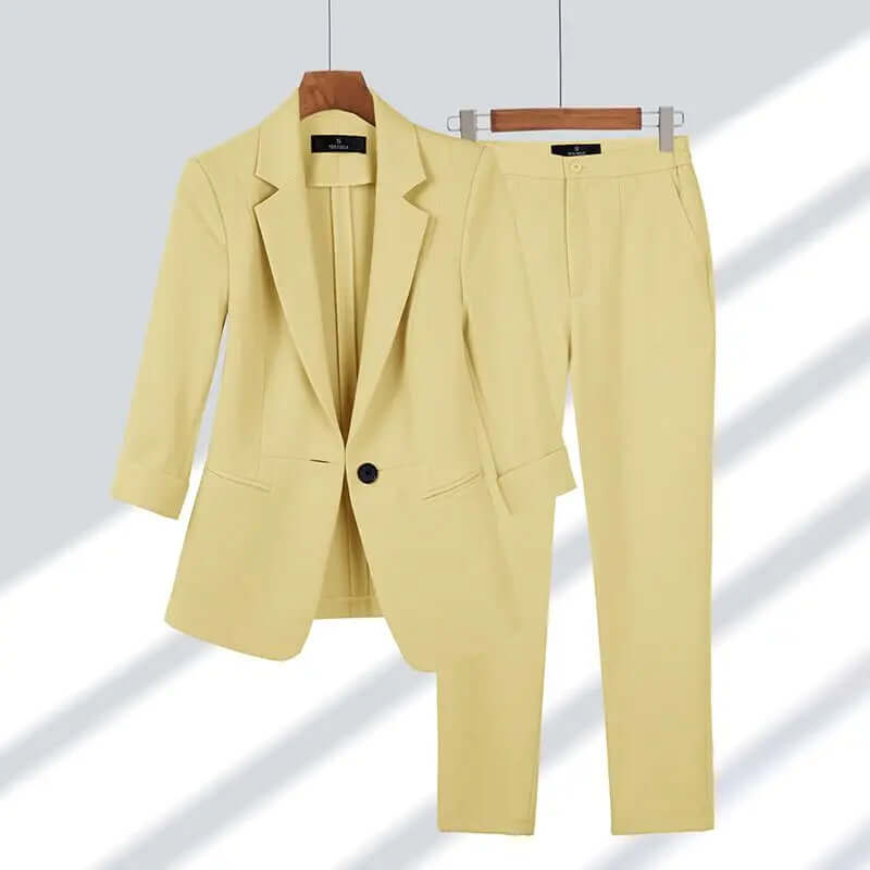 Classic navy women's tailored suit set, including a chic blazer & matching trousers, ideal for professional office fashion.