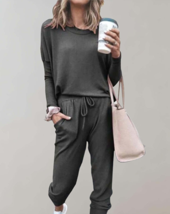 Modern elegant women's tweed two-piece skirt set. Chic business casual attire with tailored finish.