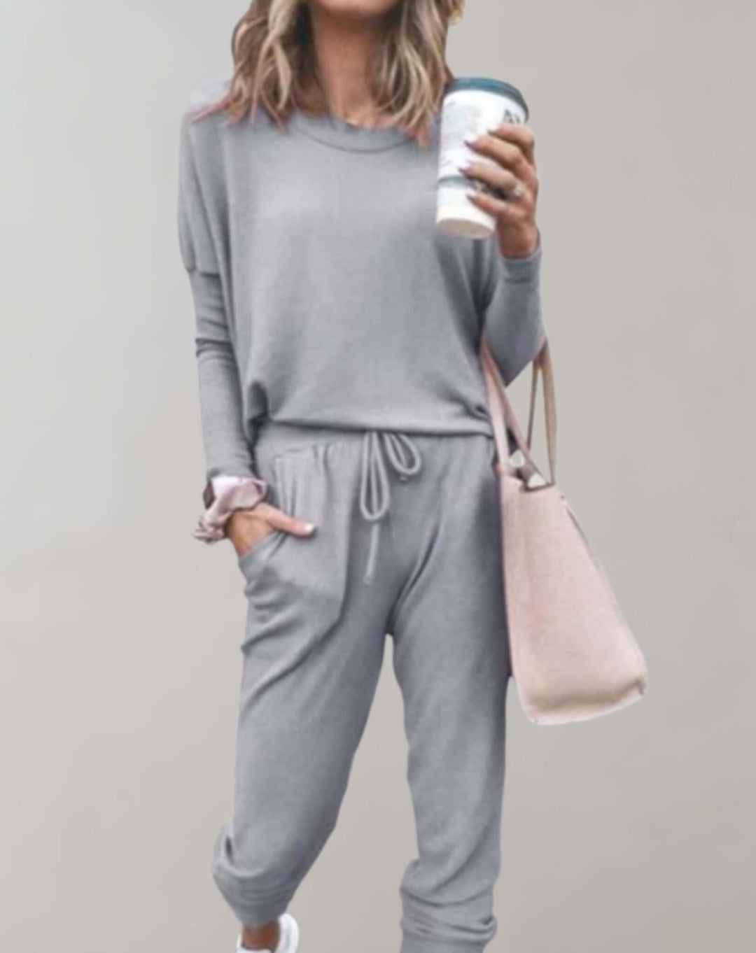 Women's elegant tweed two-piece skirt set. Chic tailored outfit for sophisticated formal wear.