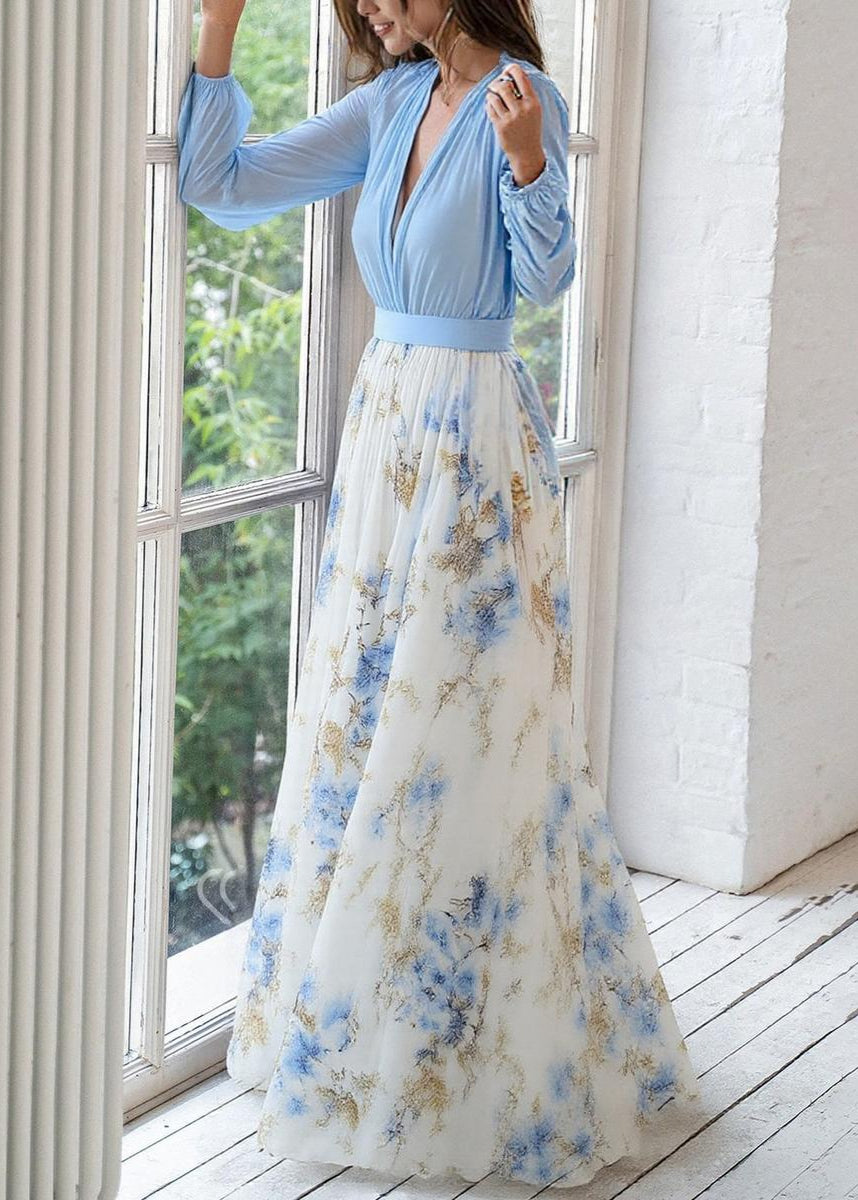 Light blue bohemian floral maxi dress for women, featuring a V-neck and long sleeves. Ideal for casual summer outings.