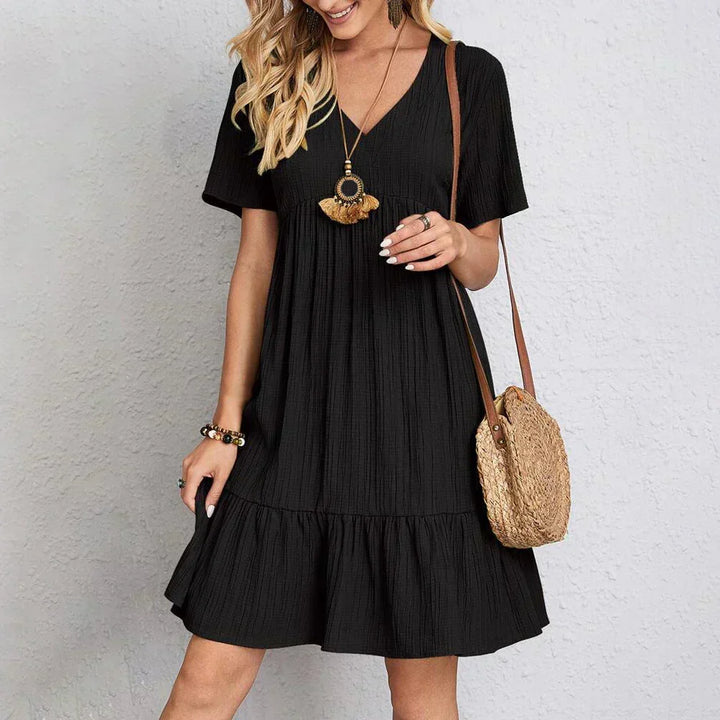 V-neck sundress styled with sandals & hat, perfect women's fashion for a relaxed vacation or casual summer day.