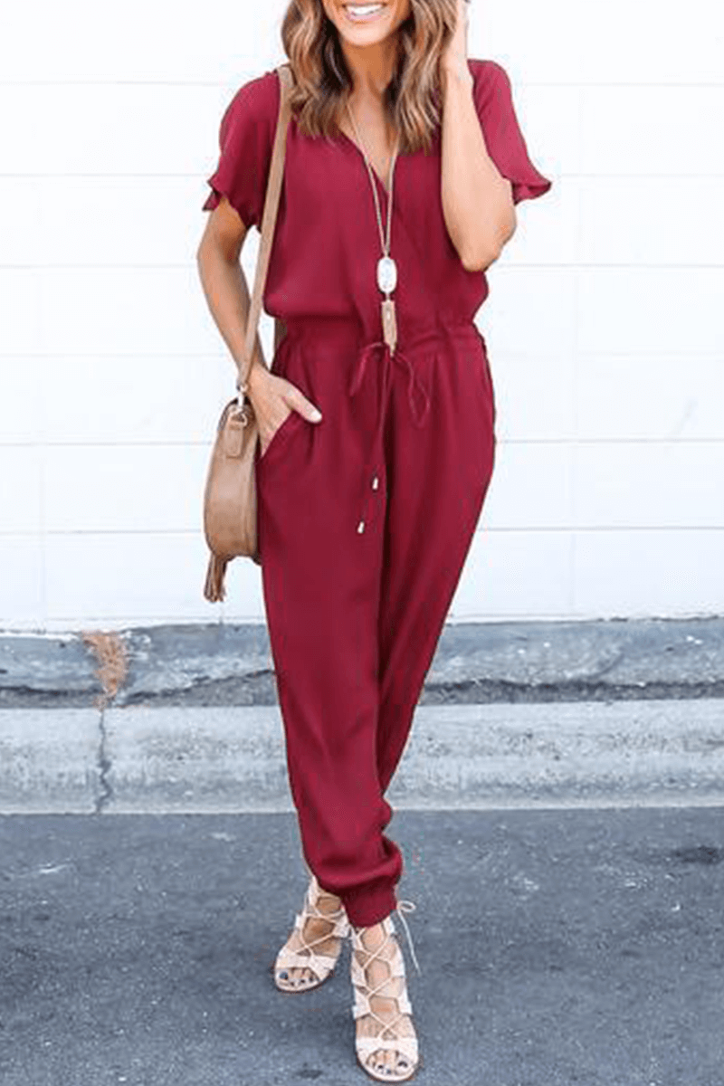 Elegant women's V-neck wide-leg jumpsuit with crossed straps. Ideal for stylish spring and summer fashion.