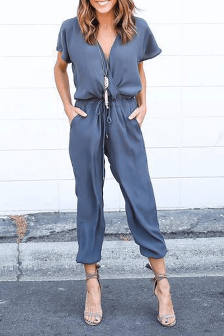 Stylish V-neck polyester jumpsuit for women, featuring elegant crossed straps and a comfortable wide-leg design.