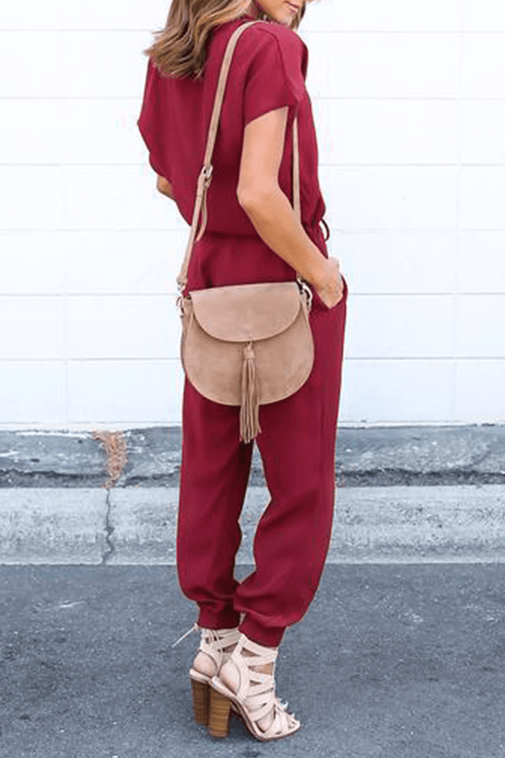 Chic women's V-neck crossed-strap jumpsuit. Comfortable polyester wide-leg for summer fashion and stylish events.