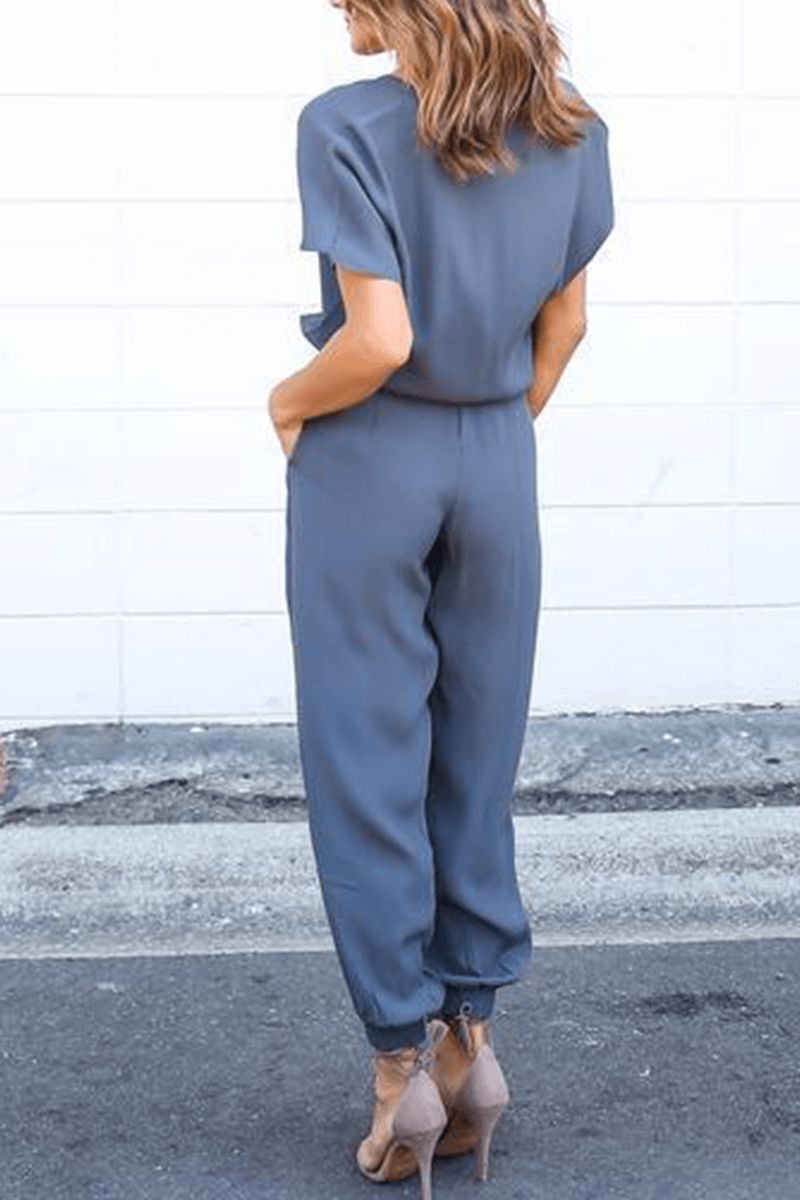 Front view of an elegant women's V-neck jumpsuit, highlighting the unique crossed-strap and wide-leg design.