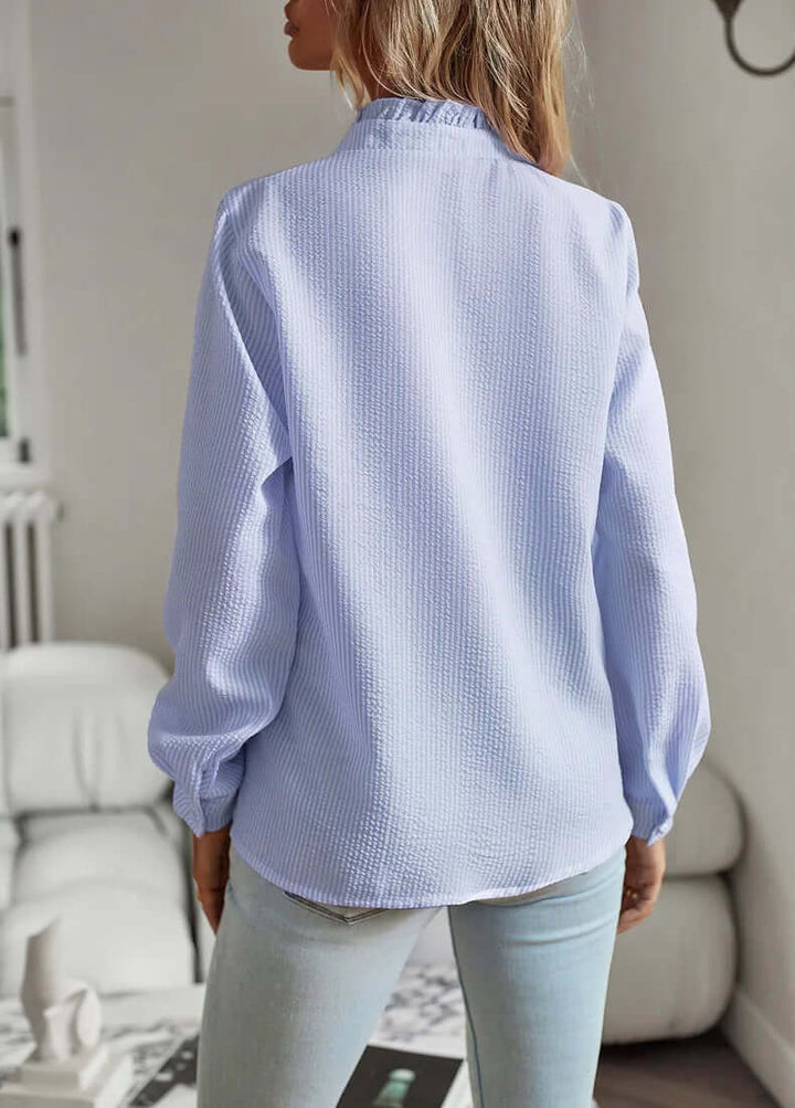 Woman models elegant white short-sleeve cotton top. Casual, comfortable everyday style, perfect for summer fashion.