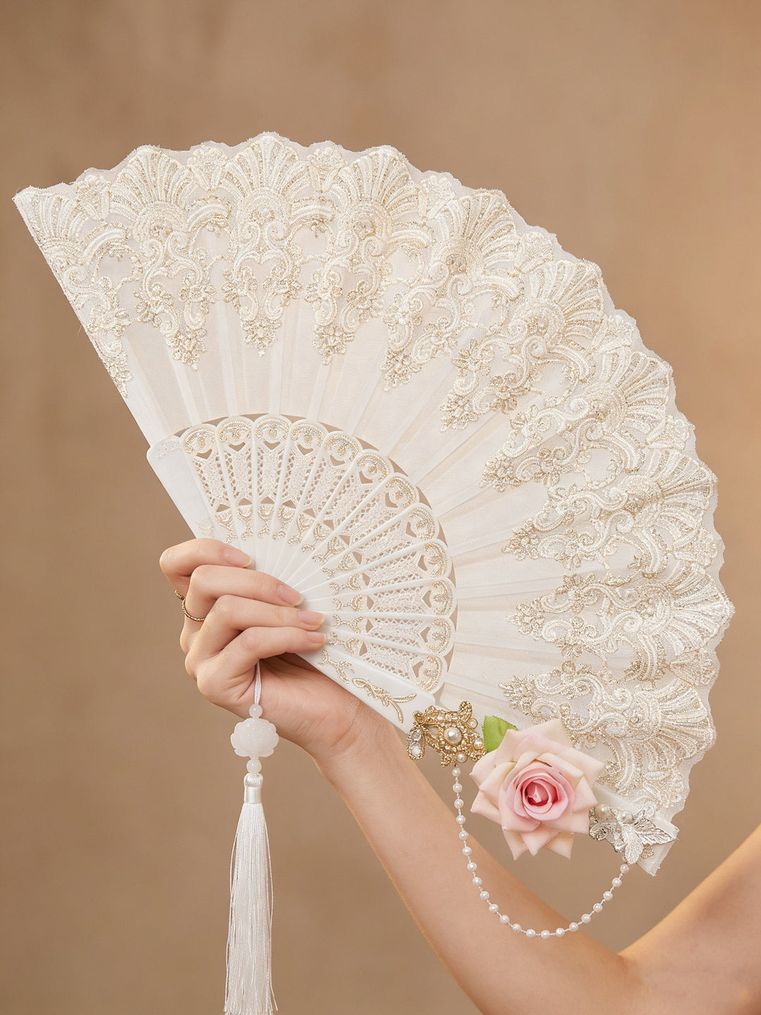 Ornate women's folding fan, perfect prom or party accessory. Stylish lace design for special events.
