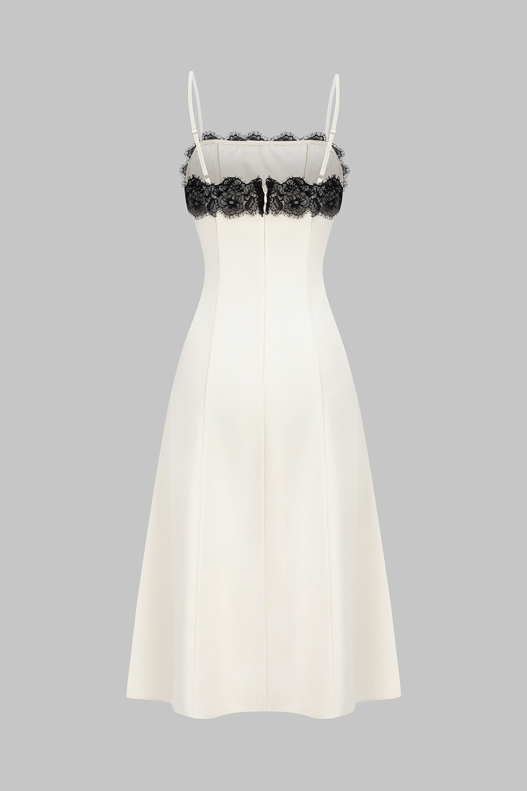 Stylish white midi party dress for women, featuring chic black contrasting lace detail for a sophisticated look.