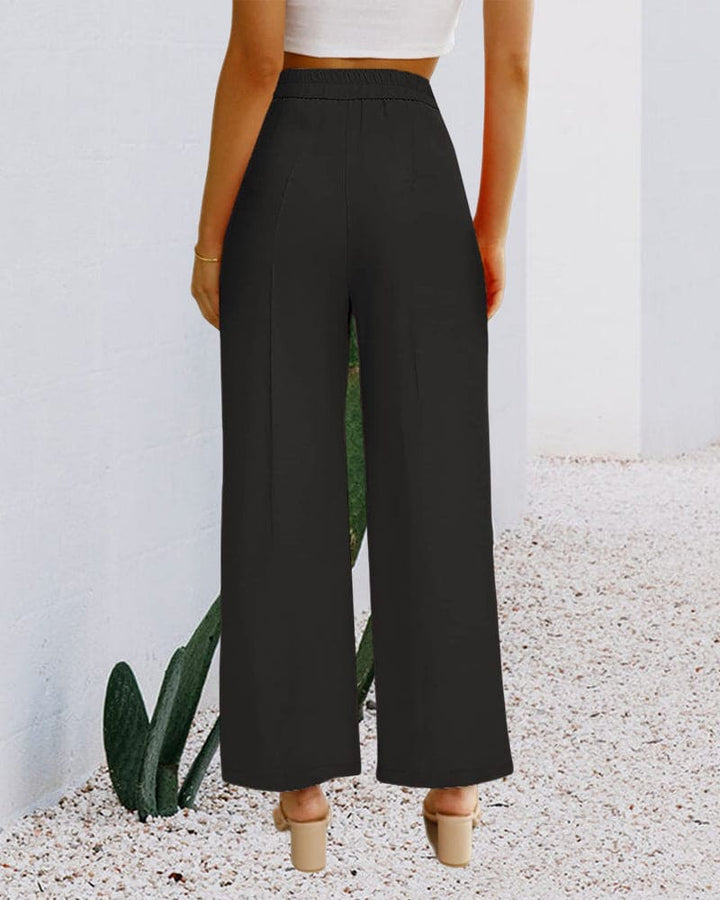 Side view of elegant women's wide-leg pants, highlighting the comfortable, stylish high-waist design.