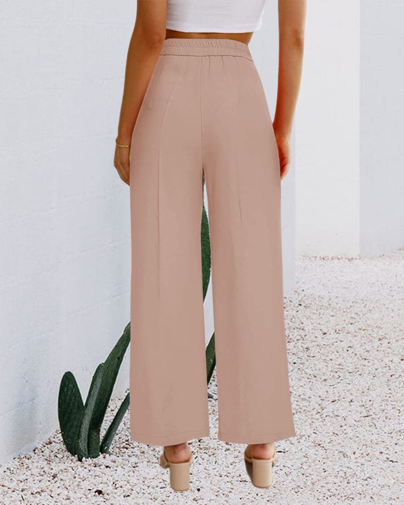 Elegant women's wide-leg dress pants paired with a blouse, perfect for a sophisticated office or event.