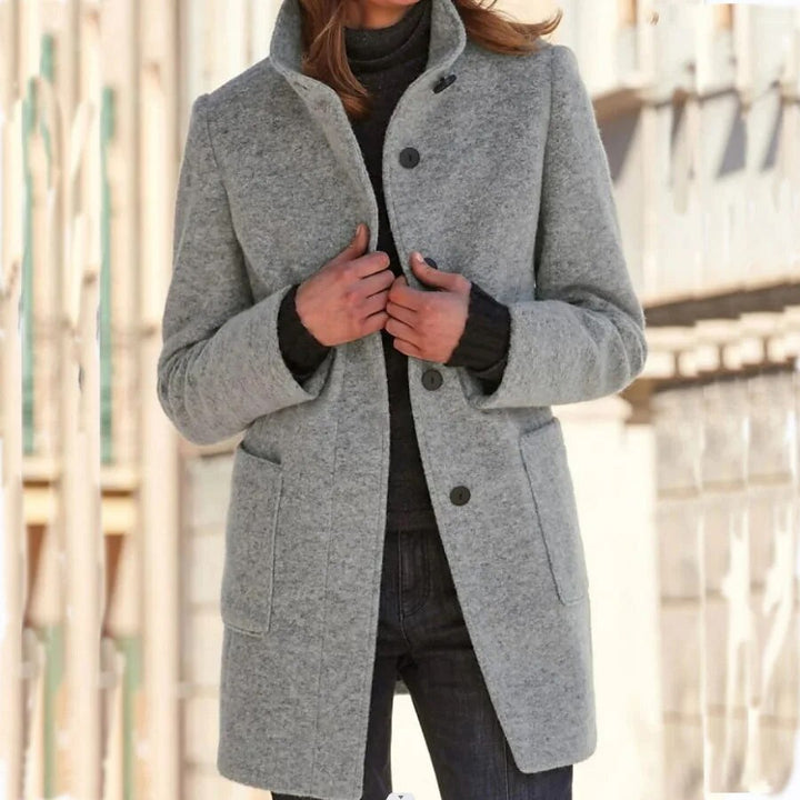 Elegant women's winter overcoat with button closure, standing collar, and classic design for cold weather fashion.