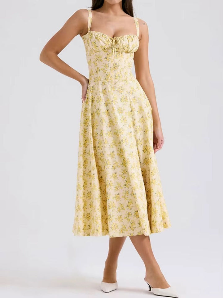 Summer-ready yellow floral midi dress for women. Sleeveless, elegant, and flowy design for vacations & parties.
