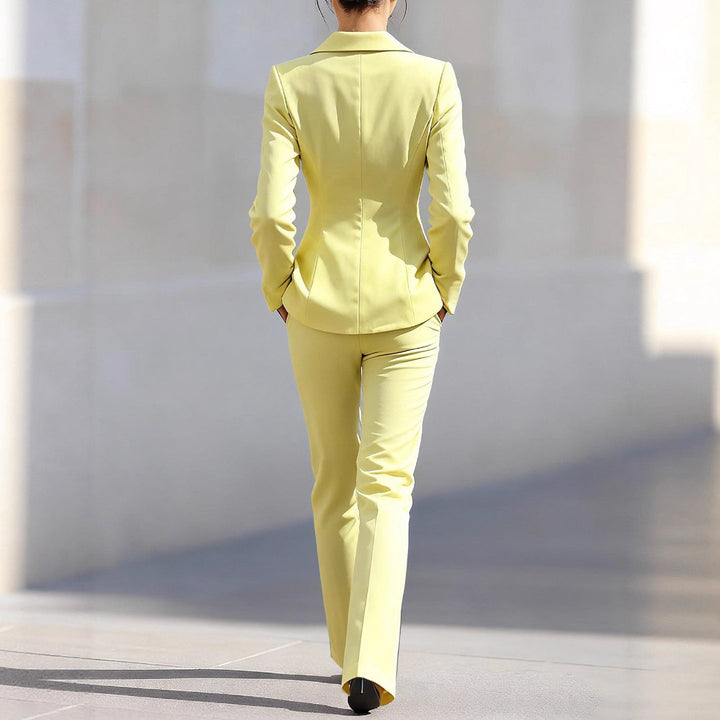 Professional women's yellow tailored blazer and matching straight-leg trousers, a versatile business outfit.
