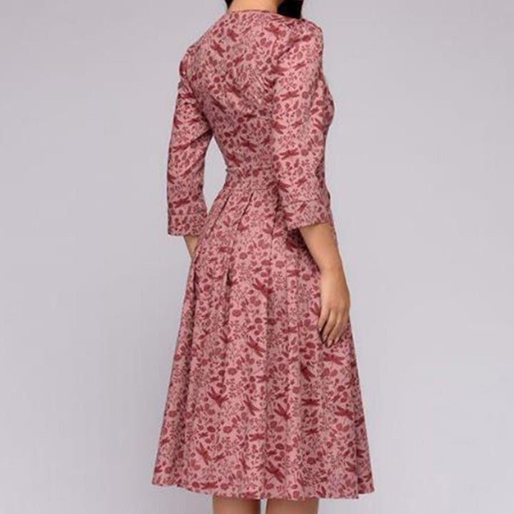 Women's A-line knee-length dress with a vibrant floral print, featuring 3/4 sleeves and a flattering fitted waist, ideal for spring occasions.