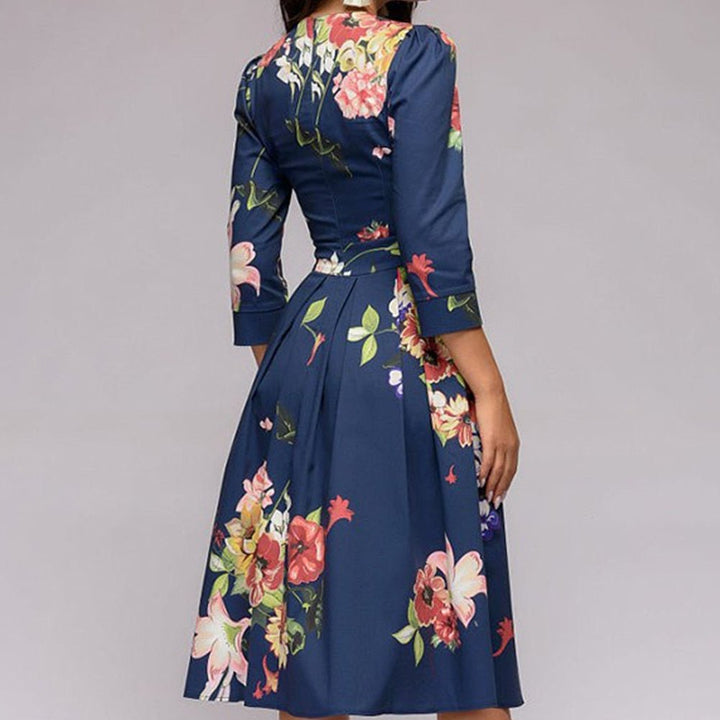 Women's A-line knee-length dress with a vibrant floral print, featuring 3/4 sleeves and a flattering fitted waist, ideal for spring occasions.