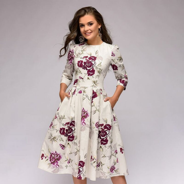 Women's A-line knee-length dress with a vibrant floral print, featuring 3/4 sleeves and a flattering fitted waist, ideal for spring occasions.