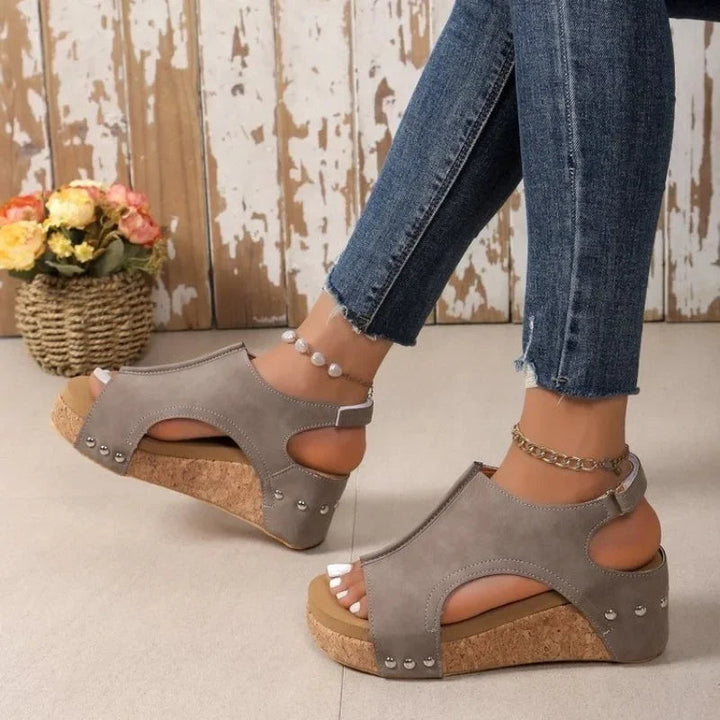 Elegant women's wedge sandals, featuring a comfortable platform heel and adjustable ankle strap for stylish spring fashion.