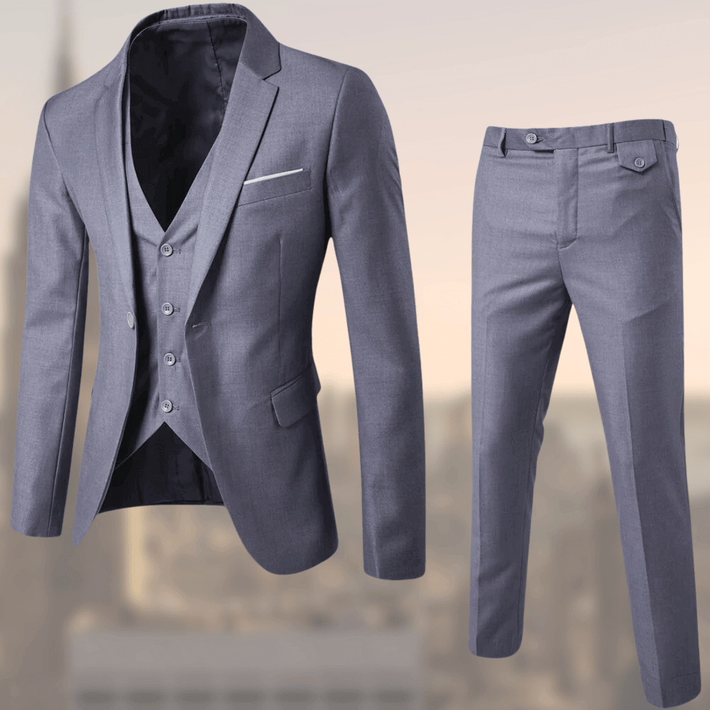 Man posing in a sophisticated three-piece suit, highlighting tailored fit and classic men's fashion elegance.