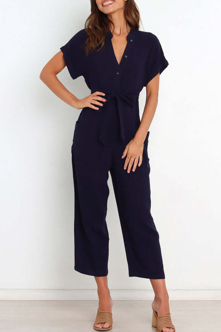 Full-length view of women's V-neck button-down jumpsuit with belted waist, perfect for versatile daily wear.