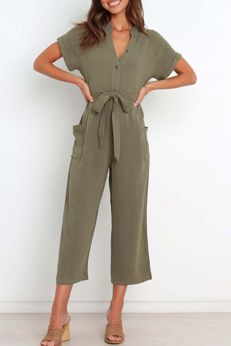 Chic women's one-piece v-neck jumpsuit with button-down front & elegant belted waist, ideal for spring fashion.