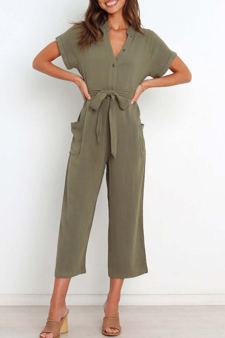 Chic women's one-piece v-neck jumpsuit with button-down front & elegant belted waist, ideal for spring fashion.