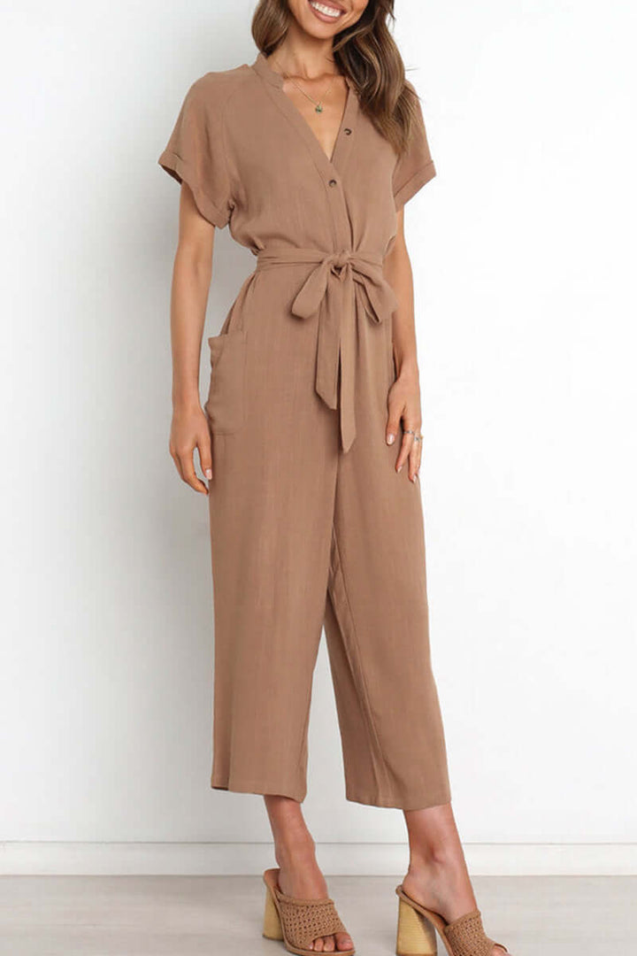 Comfortable polyester V-neck button-down jumpsuit for women, featuring a stylish belted waist, suitable for casual wear.