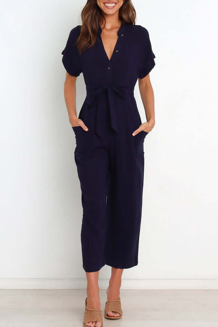 Stylish women's belted V-neck jumpsuit with button details, a versatile and elegant one-piece outfit for fall fashion.