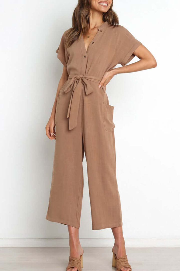 Fashionable women's polyester button-down jumpsuit, cinched with a belt at the waist, great for both casual & dressy looks.
